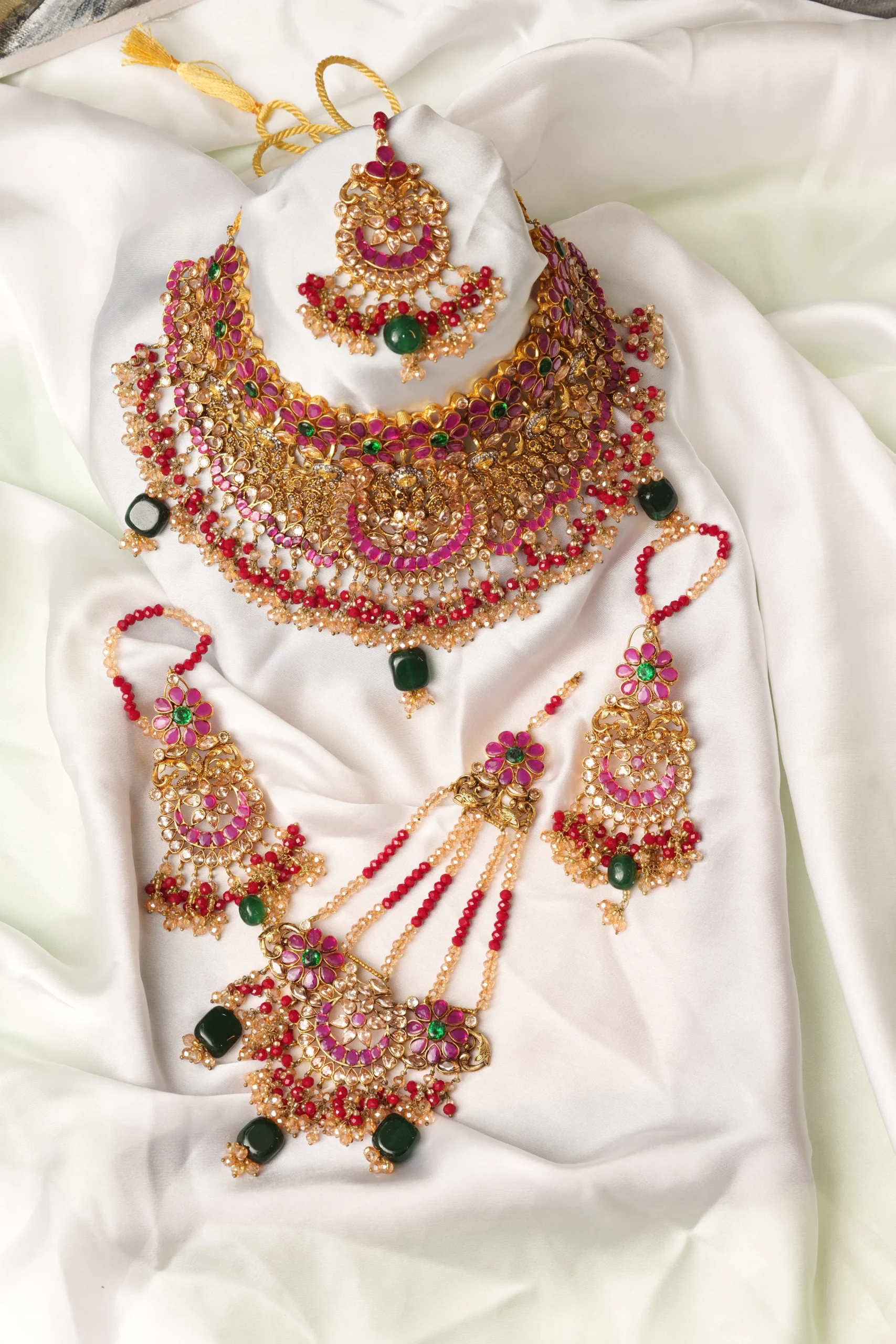 Bride wearing designer jewelry with a traditional Pakistani wedding outfit