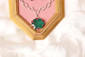 Close-up of Hexagonal Synthetic Emerald Pendant with Coral Bead Accents on Elara Green Mala Necklace