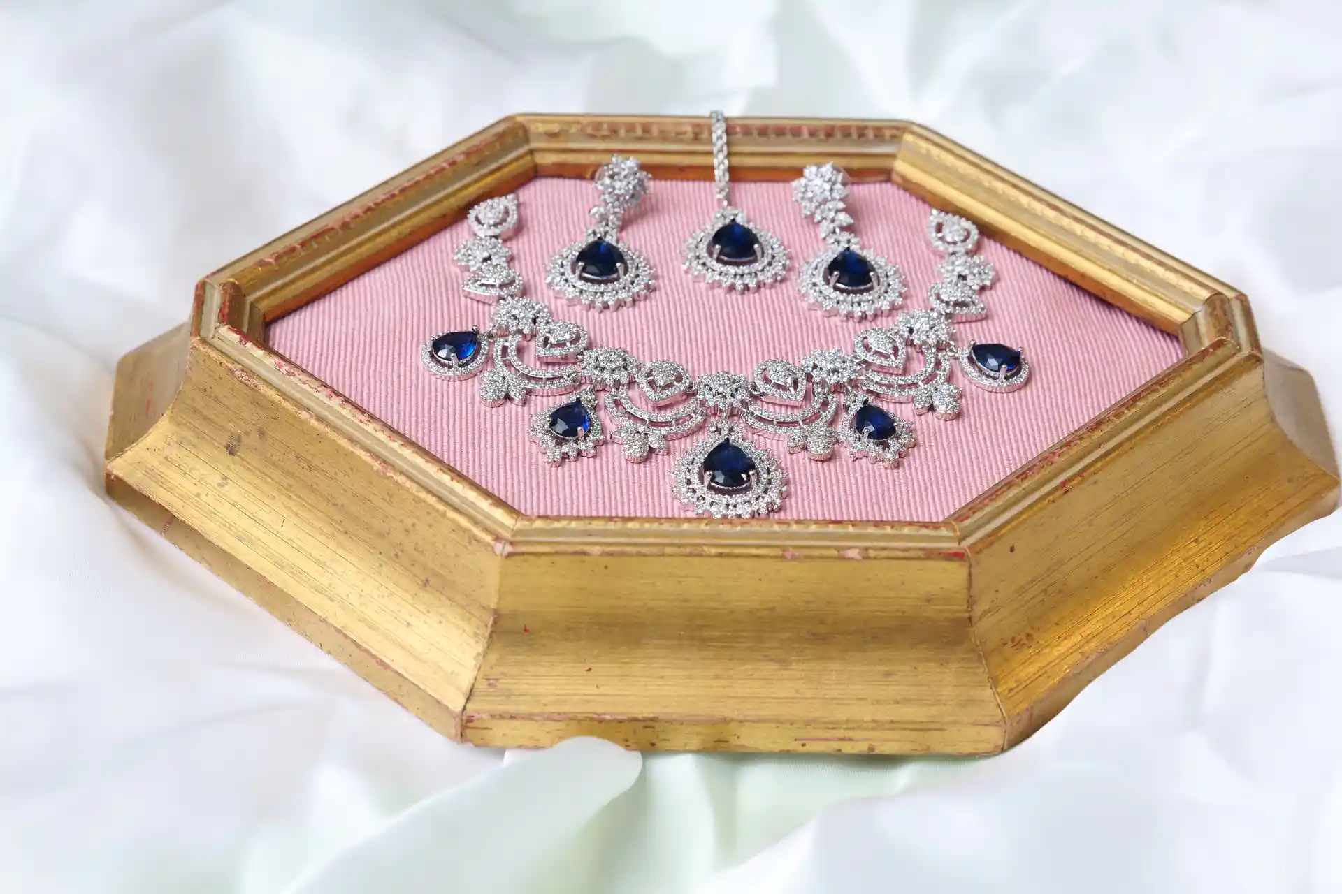 Close-up of Lumi Sapphire Necklace Showing Pear-Cut Sapphire-Tone CZ Drops and Floral Scroll Design
