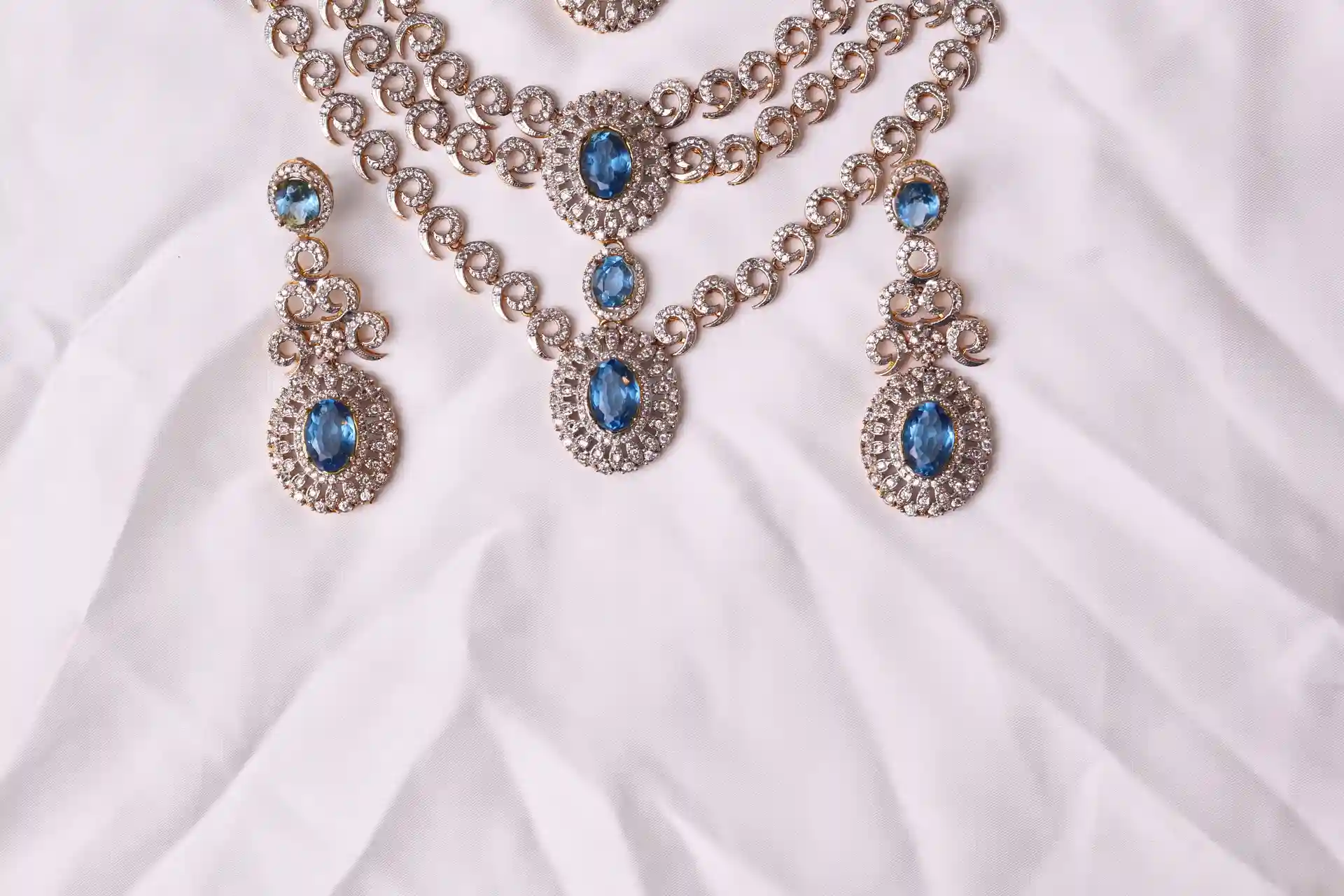 Close-up of Riva Aquamarine Necklace Pendant and Matching Drop Earrings in Ganga Jamni Finish