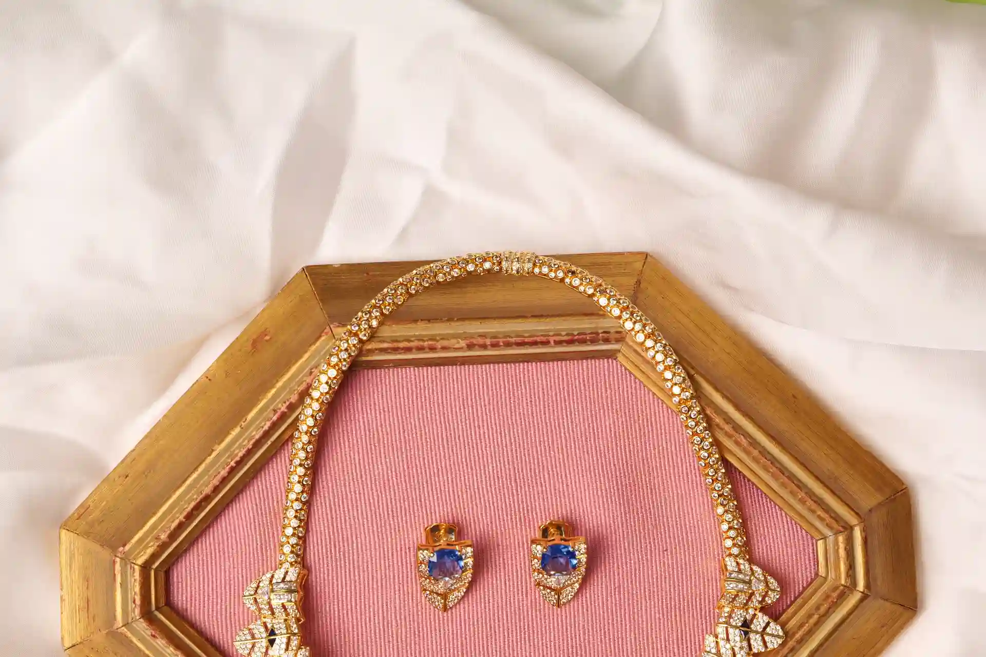 Close-up of Orra Gold Panther Necklace Clasp and Matching Blue Sapphire Drop Earrings