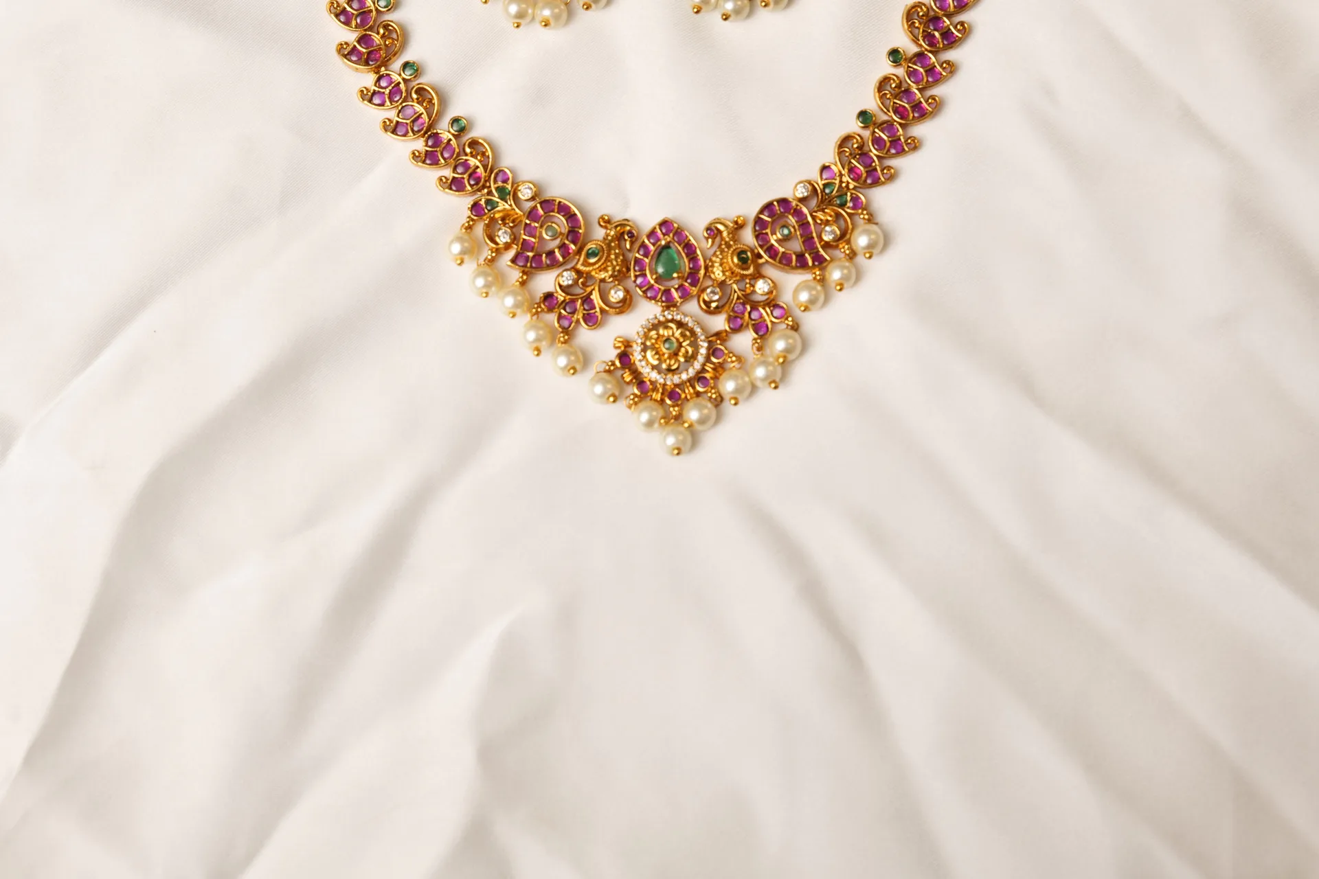 Close-up of Mehrunnisa Kundan Necklace Peacock Motif Pendant with Pearl Drop Fringe