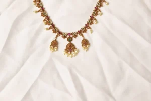 Close-up of Noor Mahal Necklace Three Pearl-Drop Pendants with Ruby and Emerald Detailing