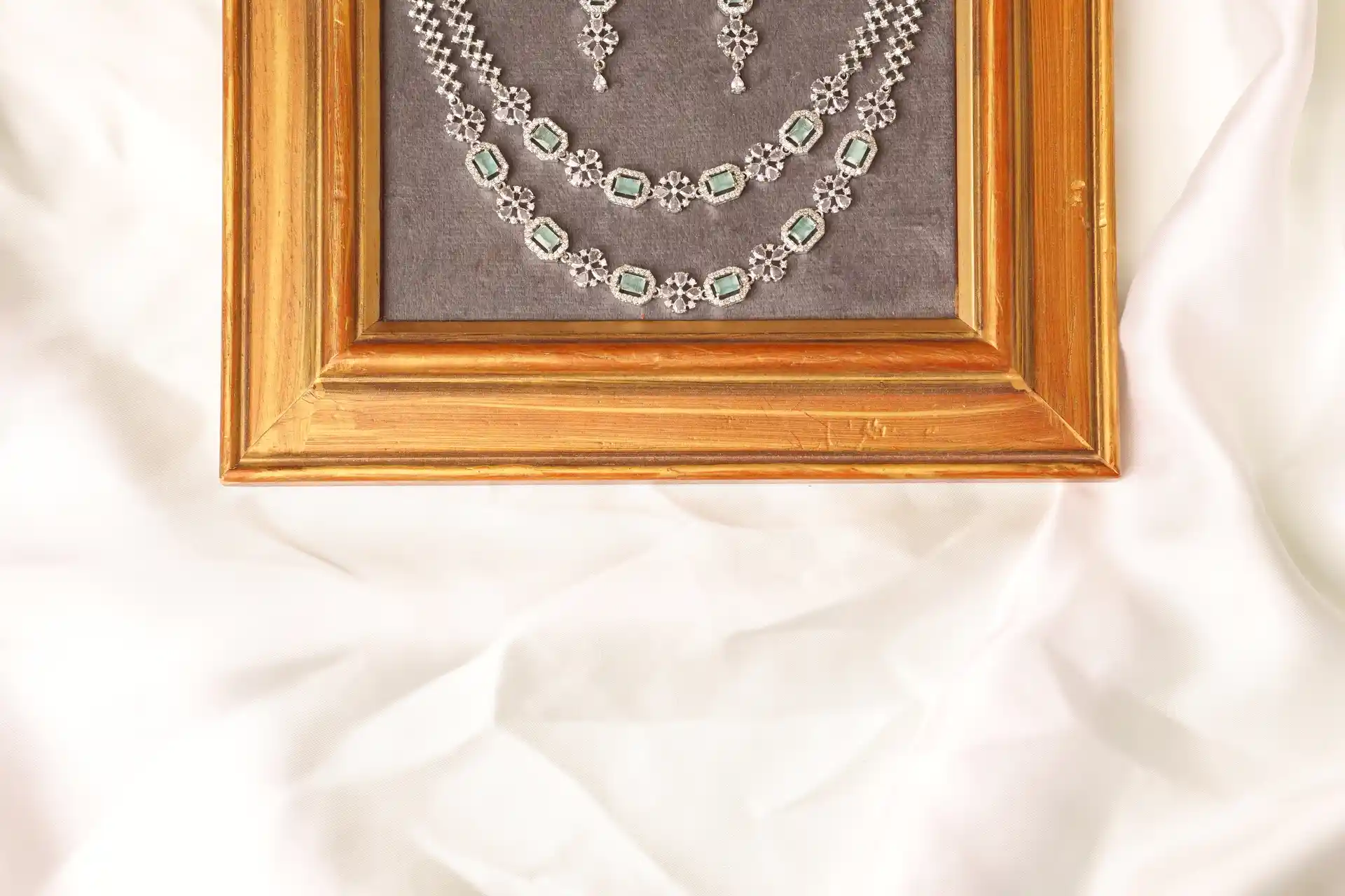 Close-up of Muse Mint Two Layered Necklace Clasp and Matching Mint Green Drop Earrings