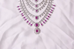 Close-up of Tess Necklace Five-Layer Cascade with Ruby-Pink Emerald-Cut Stones and Teardrop Pendant