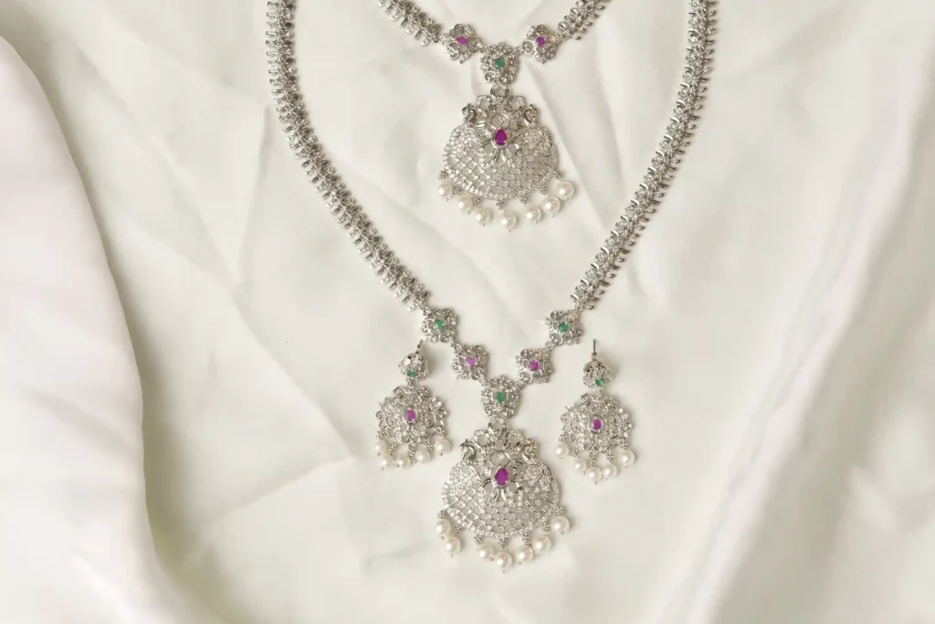 Close-up of Yara Necklace Filigree Pendant with Ruby, Emerald, and Pearl Fringe Detailing