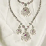 Close-up of Yara Necklace Filigree Pendant with Ruby, Emerald, and Pearl Fringe Detailing