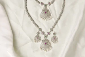Close-up of Yara Necklace Filigree Pendant with Ruby, Emerald, and Pearl Fringe Detailing