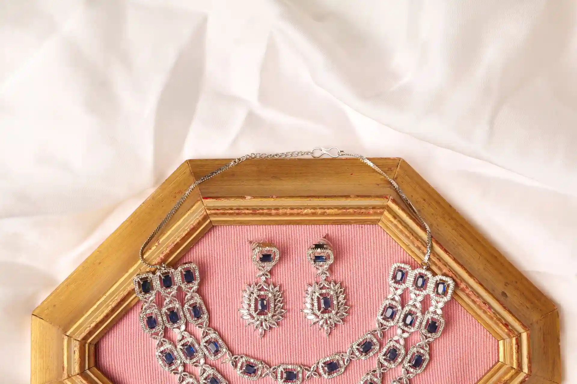 Close-up of Zhen Necklace Clasp and Matching Emerald-Cut Sapphire Drop Earrings
